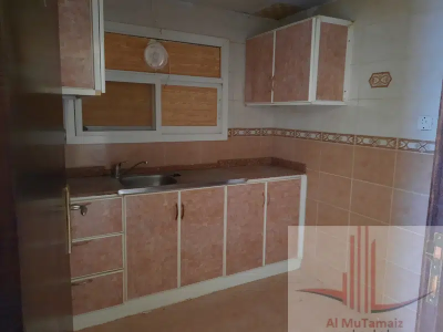 A two-room apartment with a hallway, two bathrooms, a kitchen, and a balcony is available for rent on a yearly basis for 23,000 dirhams.
