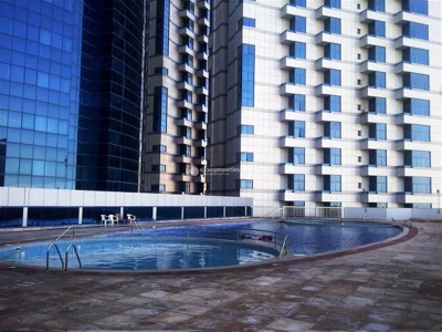 Downtown Ajman's Falcon Tower offers spacious one-bedroom apartment for sale with a hall and parking.